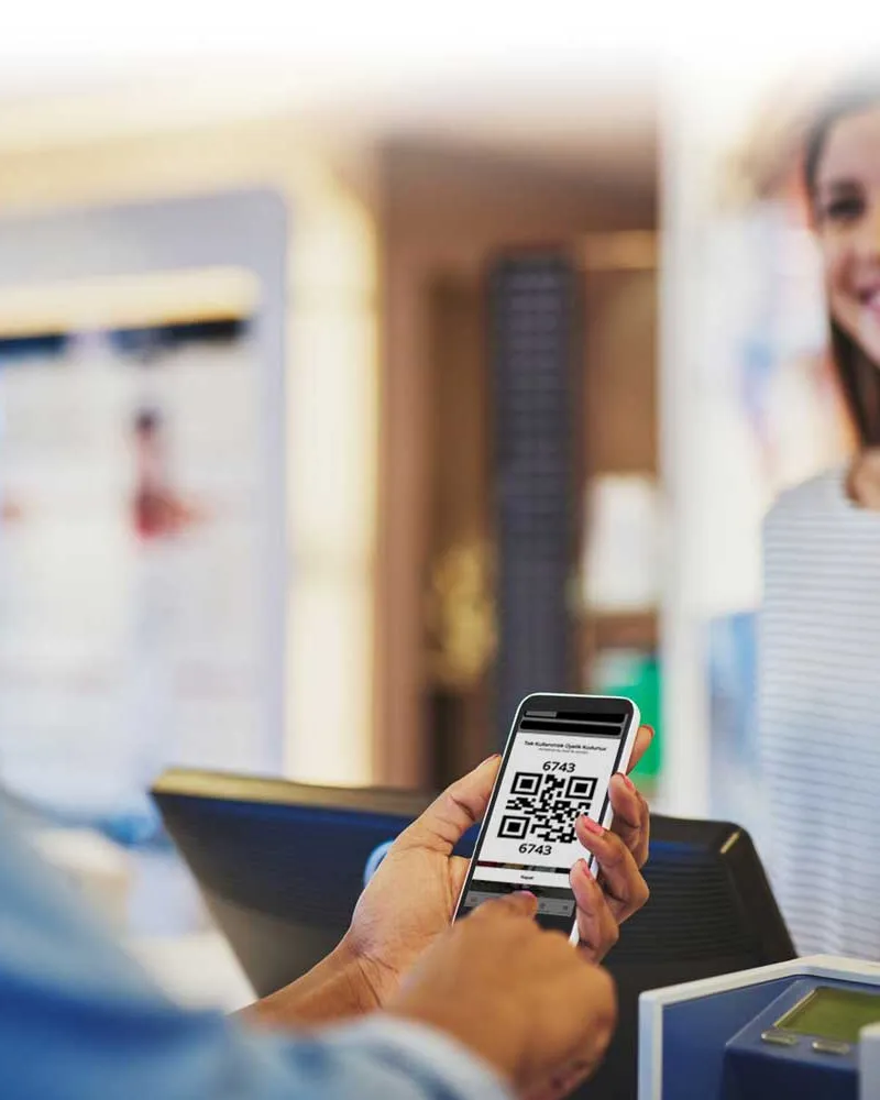 A customer showing a loyalty QR code at the register