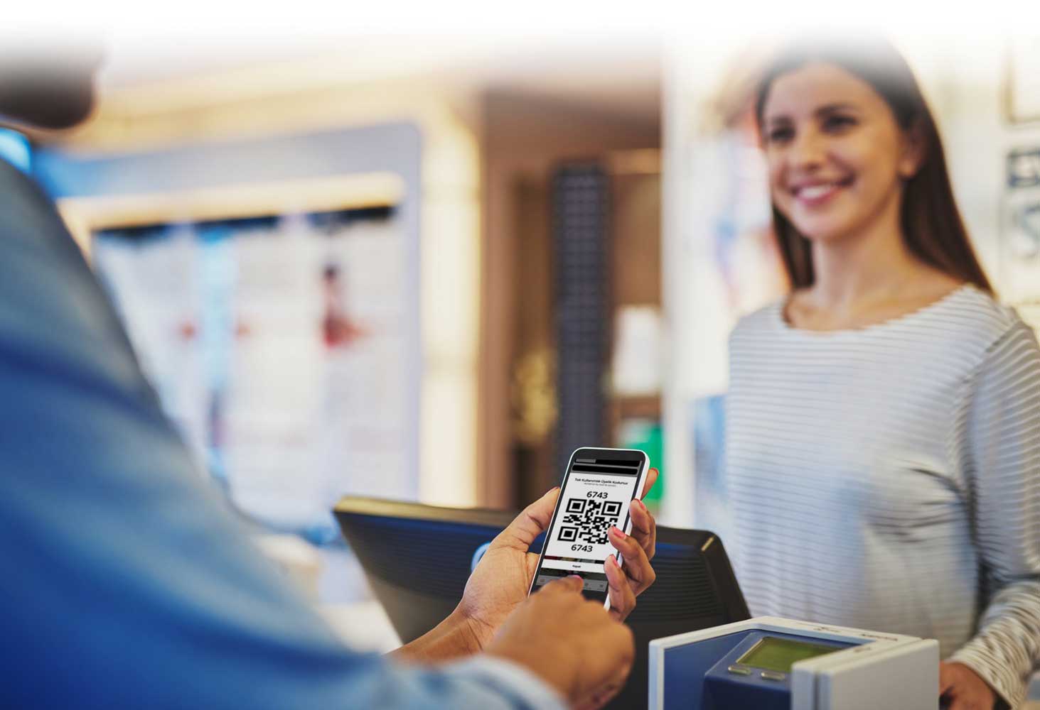A customer showing a loyalty QR code at the register